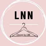 A woman wearing sunglasses, dressed in a stylish outfit.